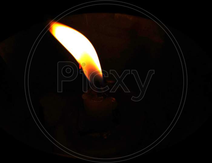 Flame of candle light on dark background