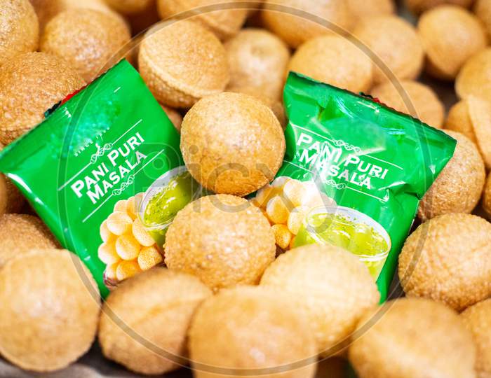 Easy To Make Or Ready To Serve Gol Gappe Pani Puri Balls With Green Masala Packets Placed In The Middle With Chili And Mint For Great Taste