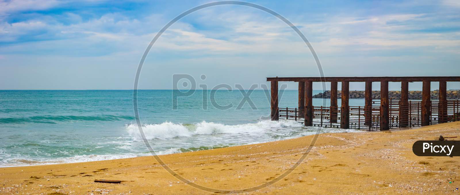 Beautiful Seascape With Destroyed Sea Bridge. Morning Beach View And Foreground Of Destroyed Quay In The Sea.
