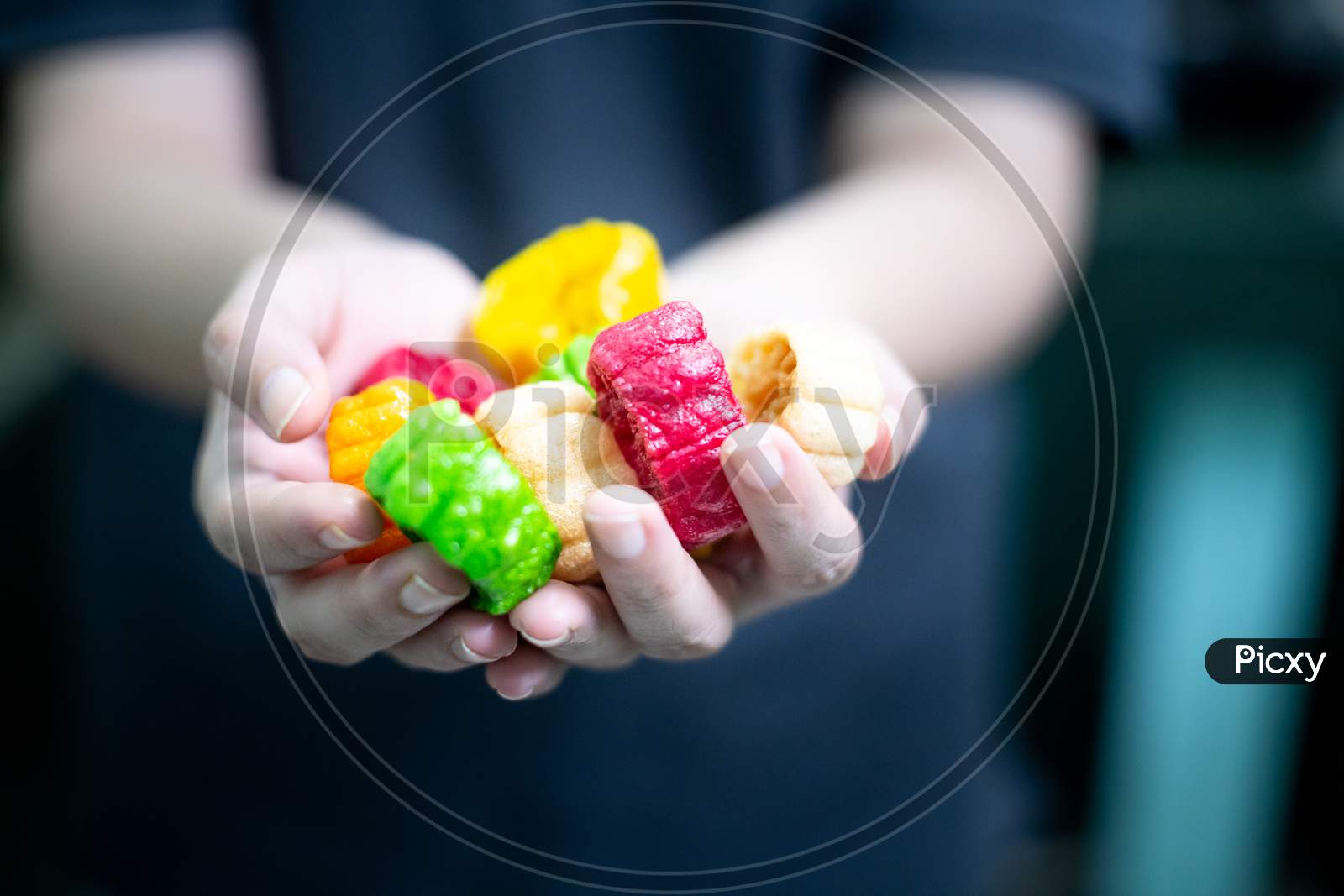 Young Indian Woman Holding Colorful Fried Food Made Of Potato Starch And Sago Called Far Far Fryums Which Is A Popular Food In North India Or A Great Snack