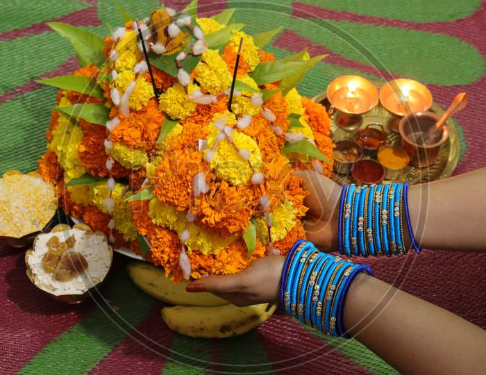 colorful flowers stacked up to create bathukamma, a specific hindu god worshiped in south india