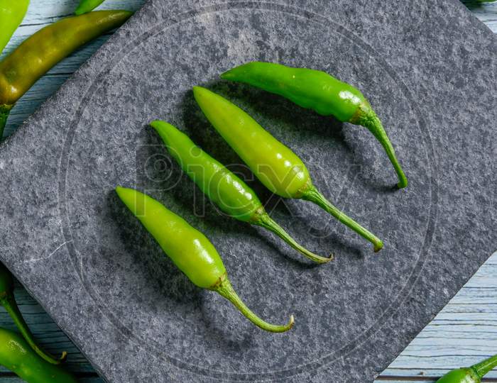 green chilly on wooden background.Fresh and Raw green chili isolated