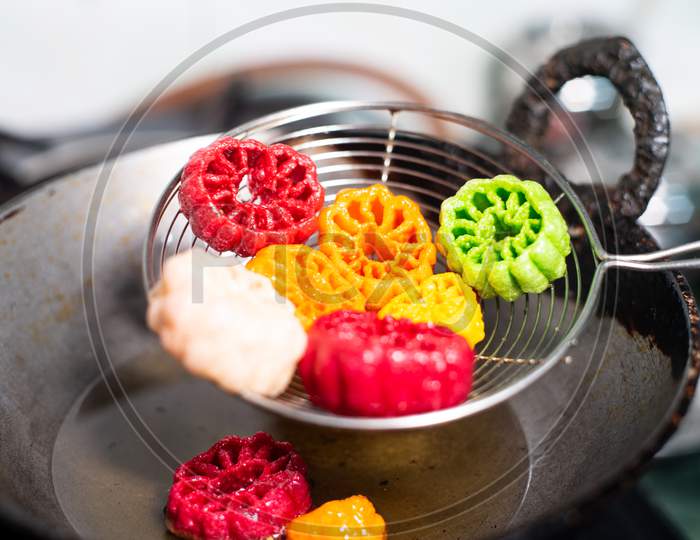 Shot Of Colorful Fryums Being Shaken To Remove Excess Oil From This Popular North Indian Snack And Street Food. This Sago And Potato Starch Delicacy Is A Popular Snack That Is Unhealthy But Very Tasty