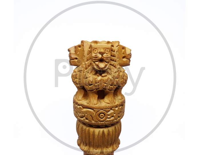 Lion face wooden replica of Ashoka Stambha isolated on white background