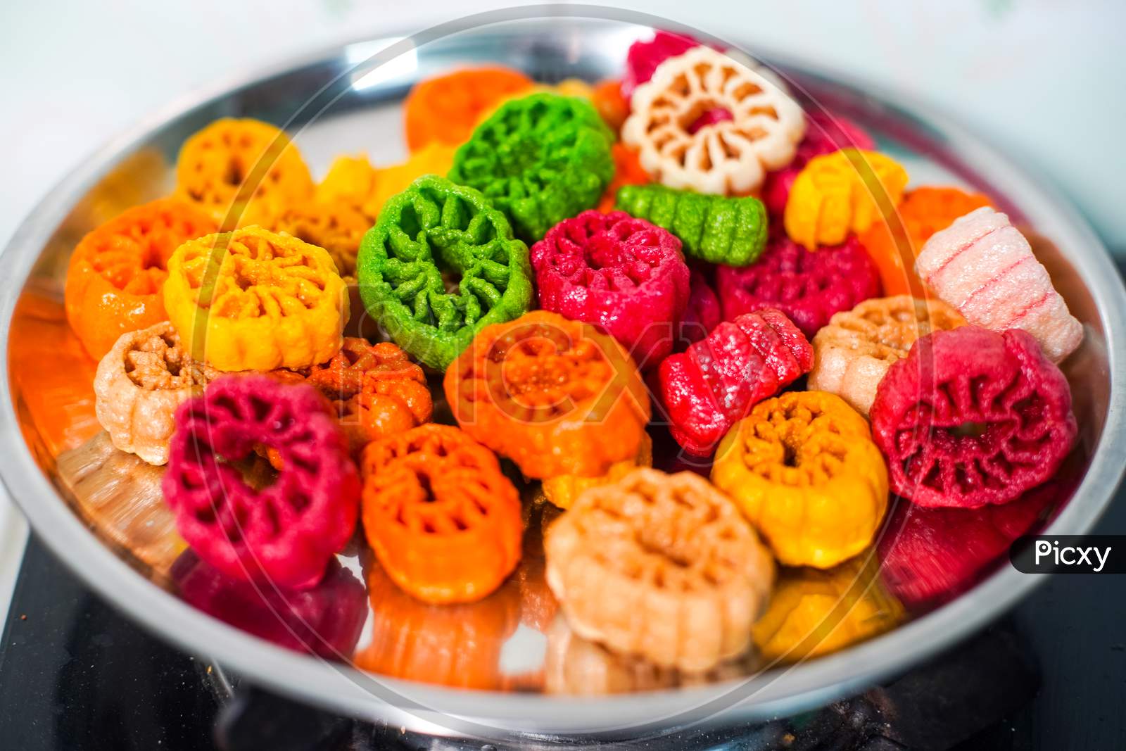 Shot Of Colorful Fryums Being Deep Fried In Hot Oil Bubbling And Sizzling With Bubbles Forming And Size Increasing Of This Popular North Indian Snack And Street Food