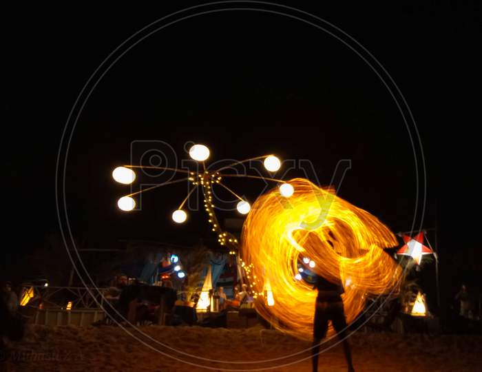 Fire dancing at night from the beach in goa