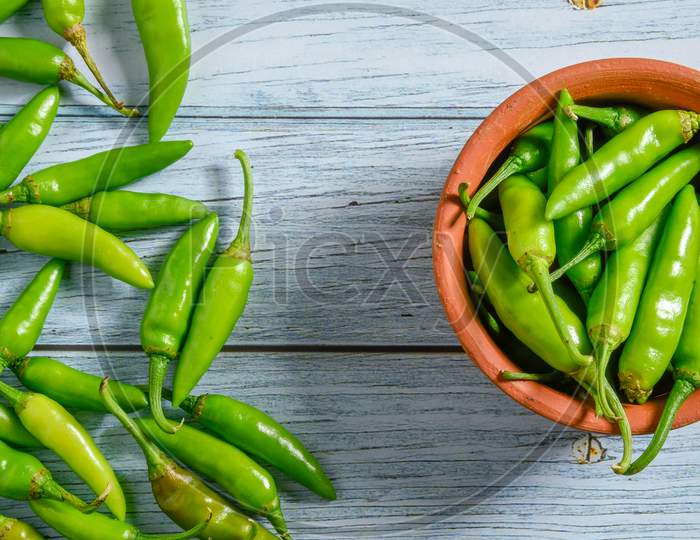 green chilly on wooden background.Fresh and Raw green chili isolated
