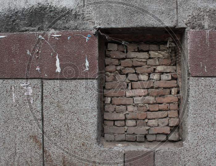 Old Brick Wall With Brick Filled Window.