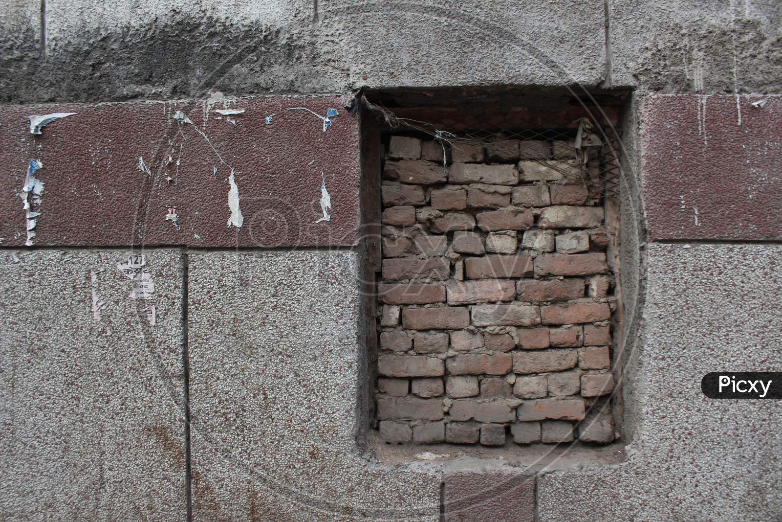 Old Brick Wall With Brick Filled Window.