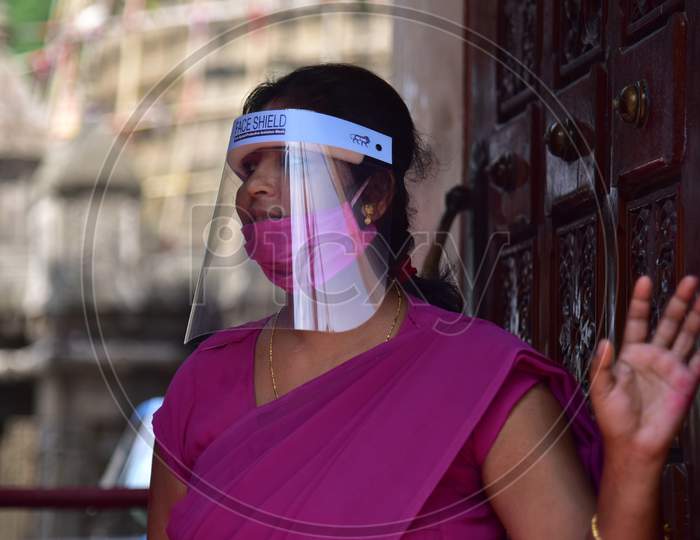 A women security guard wearing a face mask and shield inside the premises of Kamakhya Temple, as it re-opens for public after a gap of nearly six months due to coronavirus lockdown with certain restrictions, in Guwahati, India on October 11, 2020