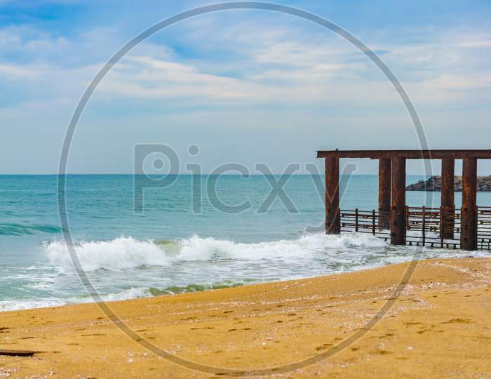 Beautiful Seascape With Destroyed Sea Bridge. Morning Beach View And Foreground Of Destroyed Quay In The Sea.