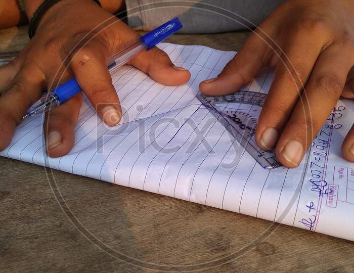 School kid drawing on paper