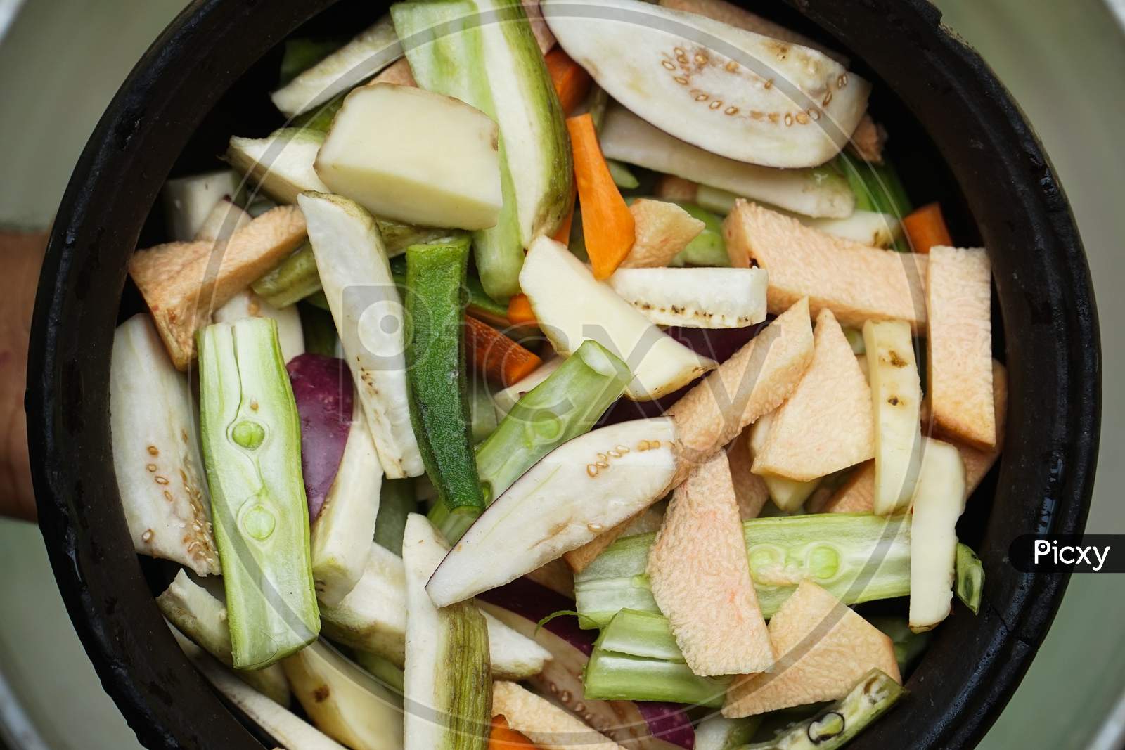 Close Up Image Of Fresh Sliced Vegetable Pieces In A Clay Pot