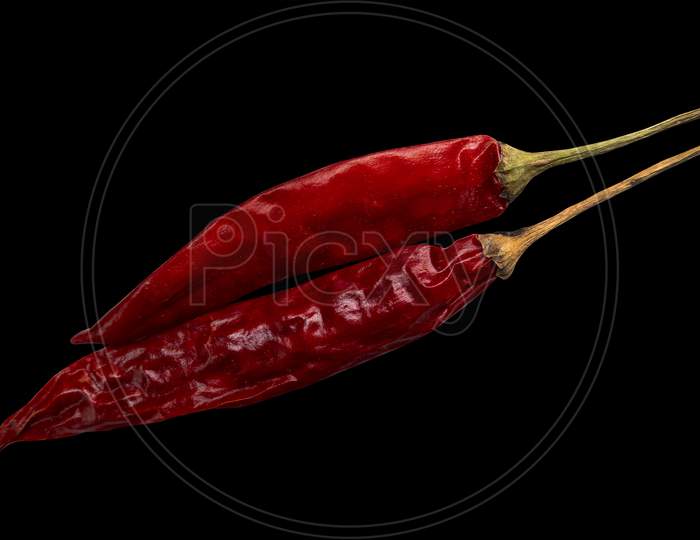Top Shot Of Red Chillies Isolated On Black Background