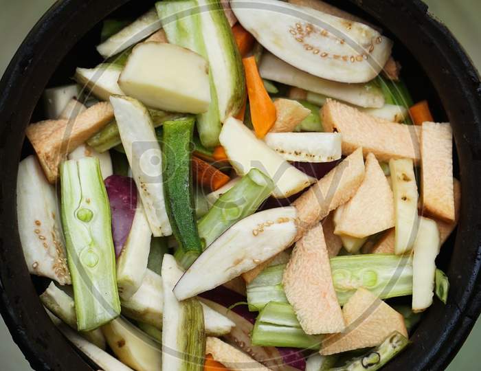 Close Up Image Of Fresh Sliced Vegetable Pieces In A Clay Pot