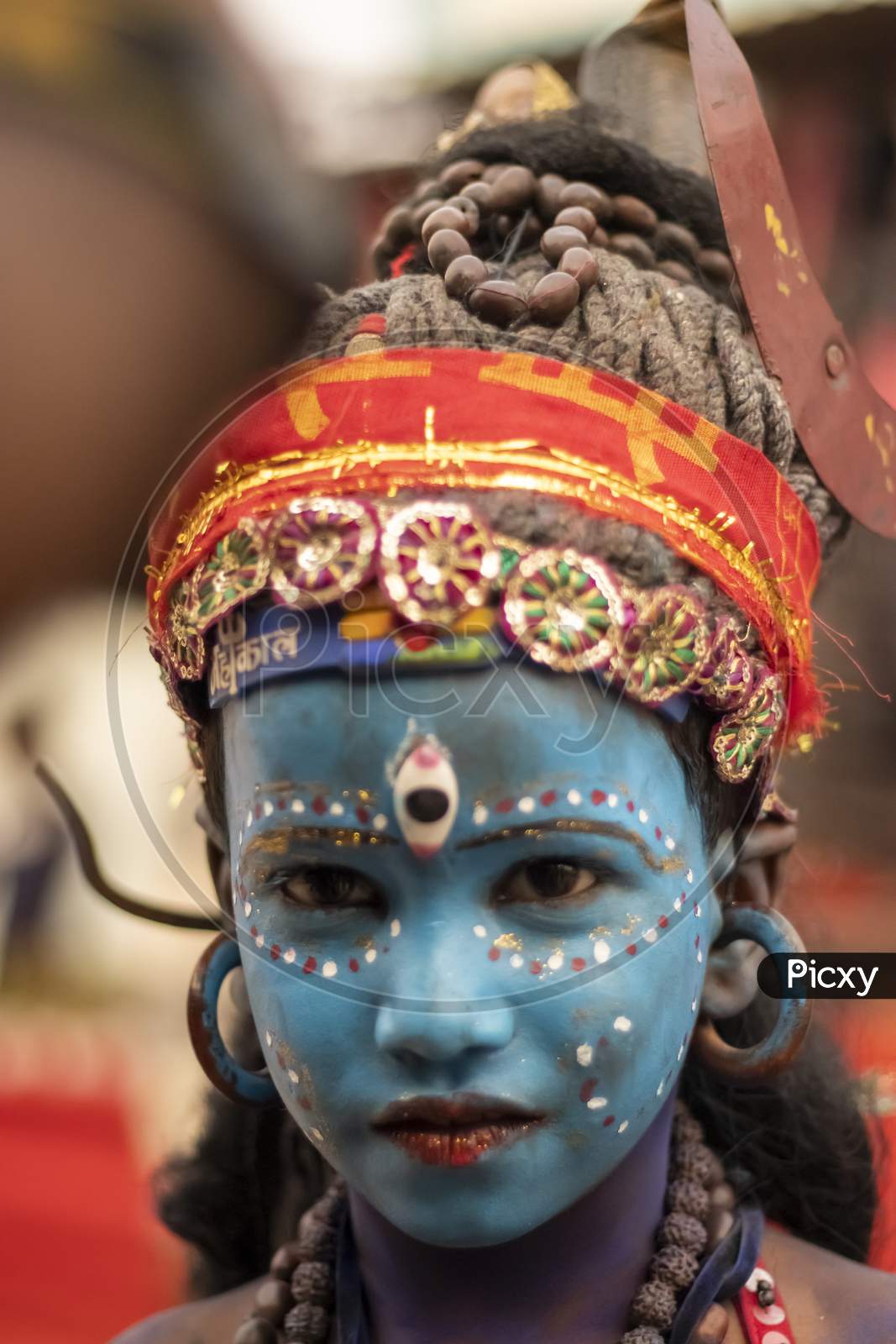 A portrait of a poor kid dressed as lord Shiva in Pushkar Fair