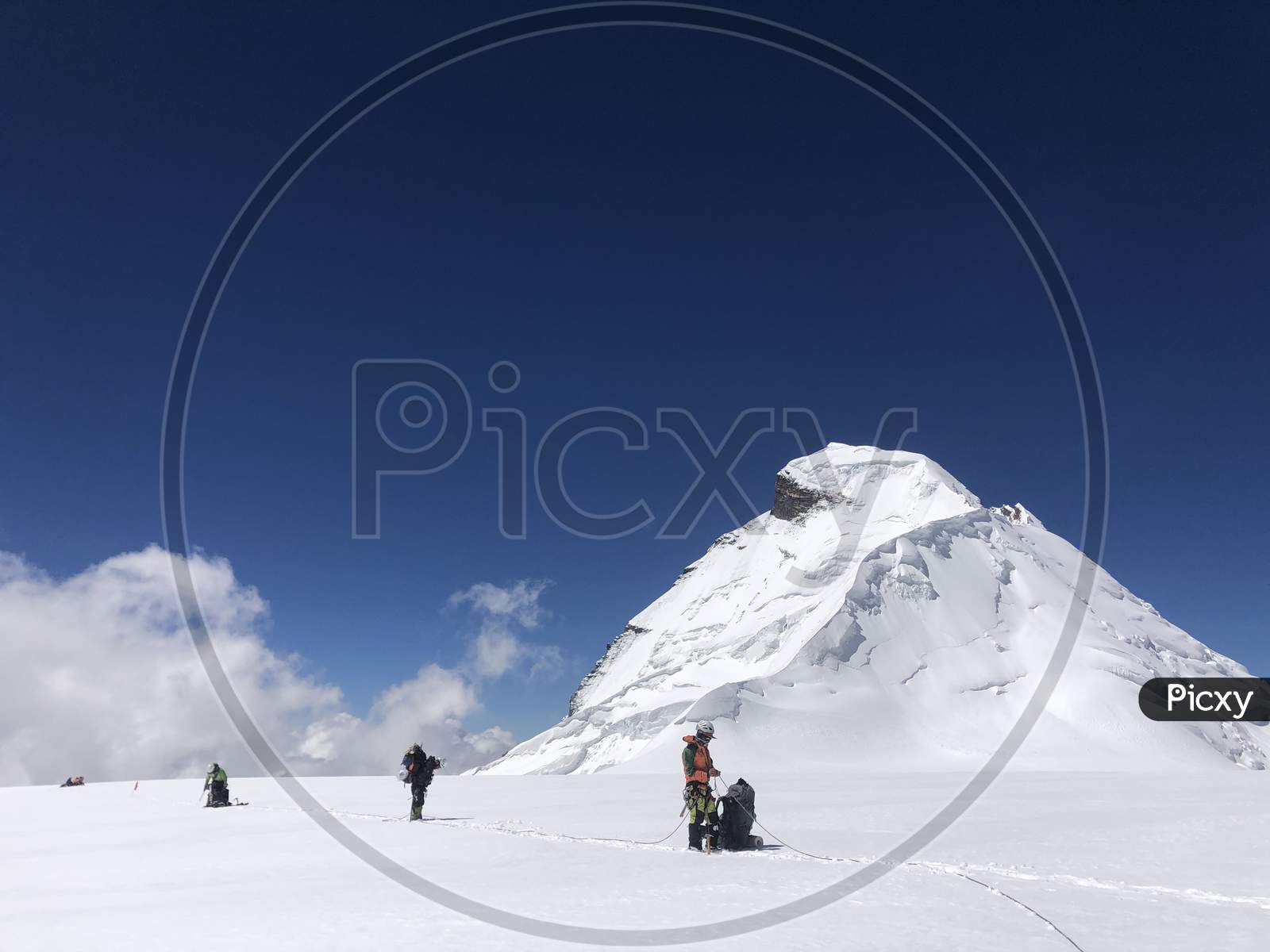 Mountaineers walking roped up at 6000 mtrs. Mountain photography