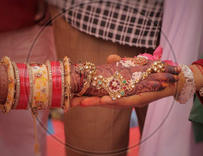 a photo of indian wedding,.A couple are holding hand each other.