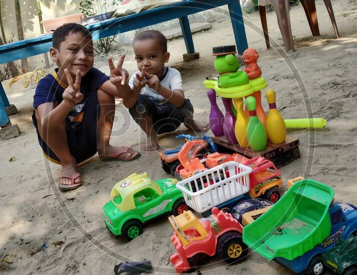 Two little kids playing and enjoying with toys