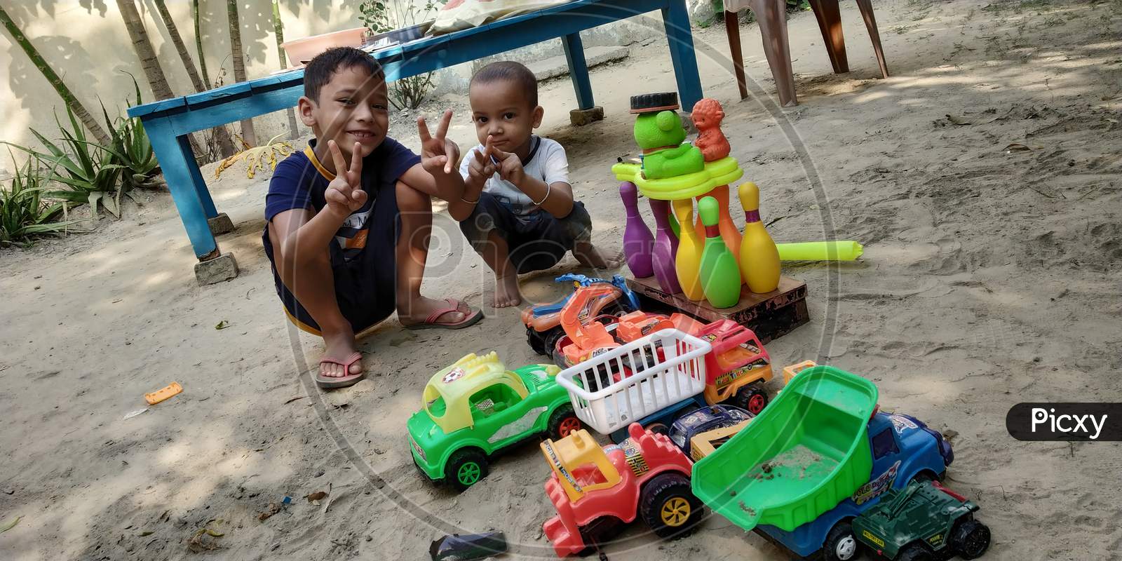 Two little kids playing and enjoying with toys