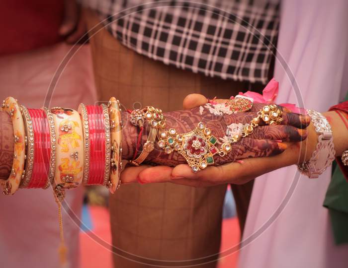 a photo of indian wedding,.A couple are holding hand each other