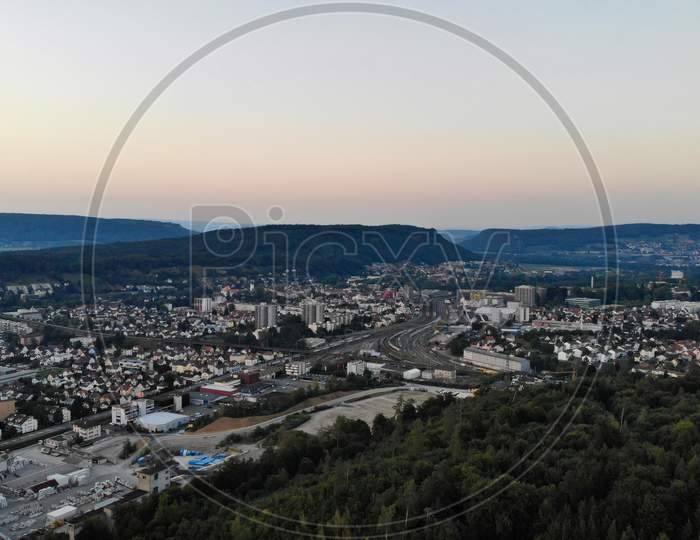 Aerial View Over Brugg After Sunset. Industry, Train Station And Residential Area Of Brugg.