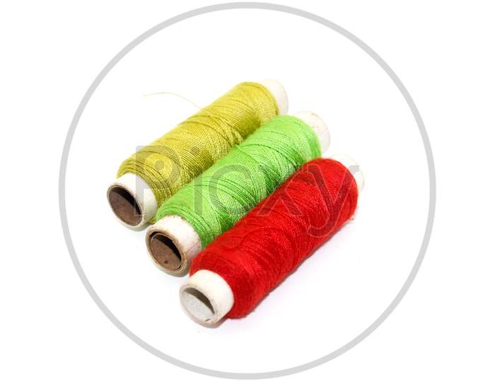 A Picture Of Thread Rolls On White Background