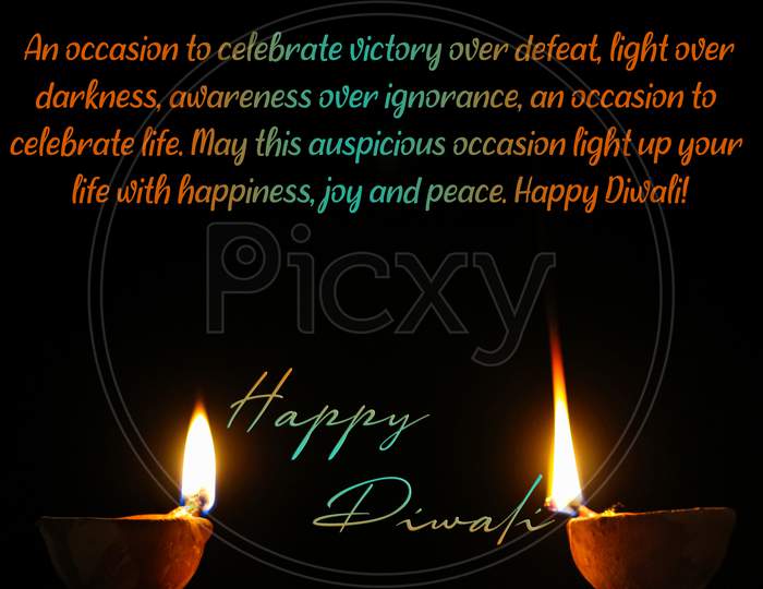 Illustration message of Happy diwali message wish with two glowing diyas on black background