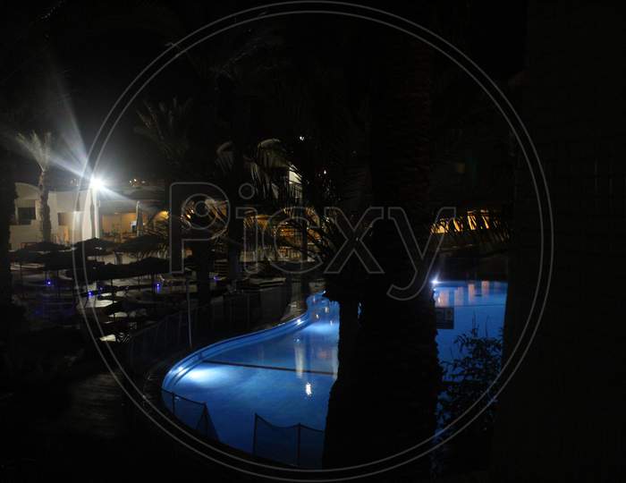 A large and beautiful pool sparkles at night