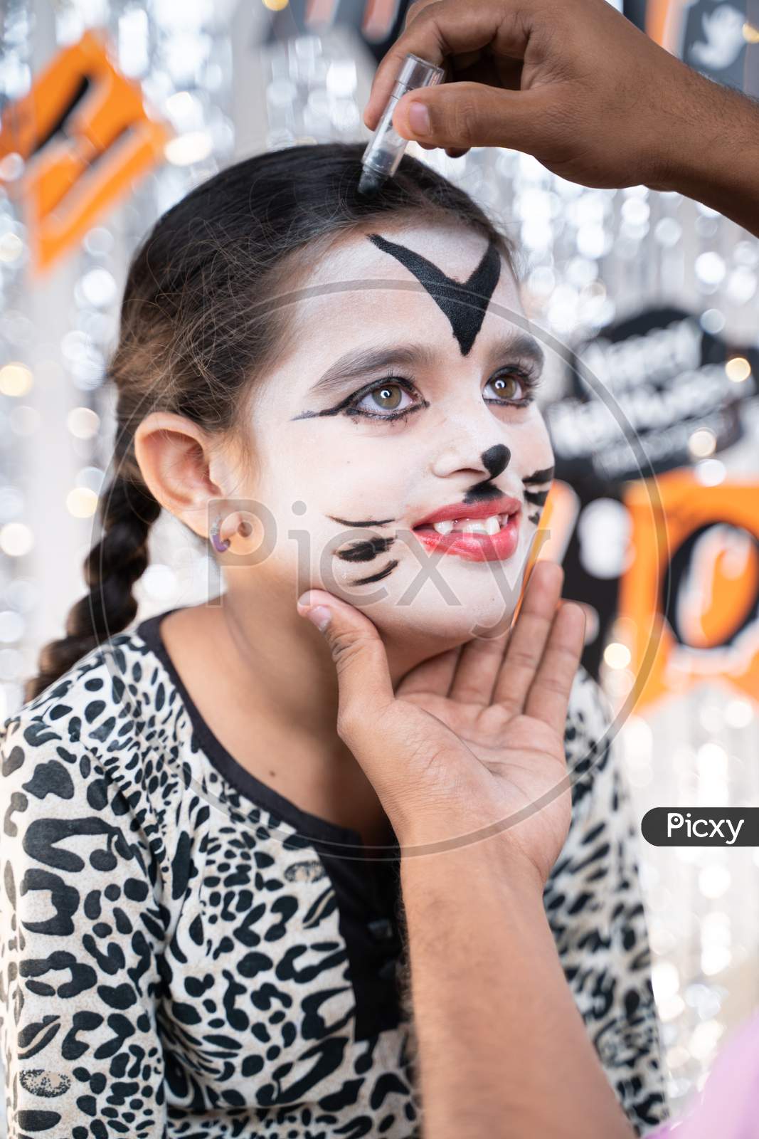 Parent Helping Her Daughter To Get Ready For Halloween By Doing Make-Up - Concept Of Halloween, Holiday And Childhood Festival Celebration And Preparation.