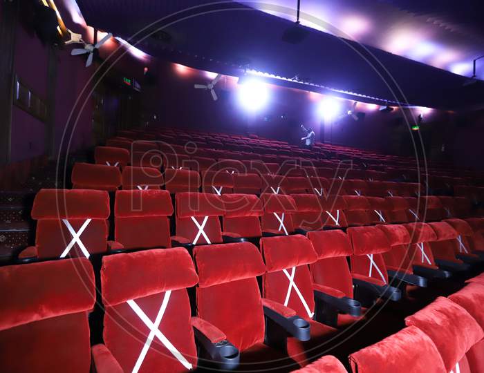 Tape is displayed on seats to implement safe distancing measures at a film theater in the  Delite cinema in New Delhi, India, on October. 13, 2020.