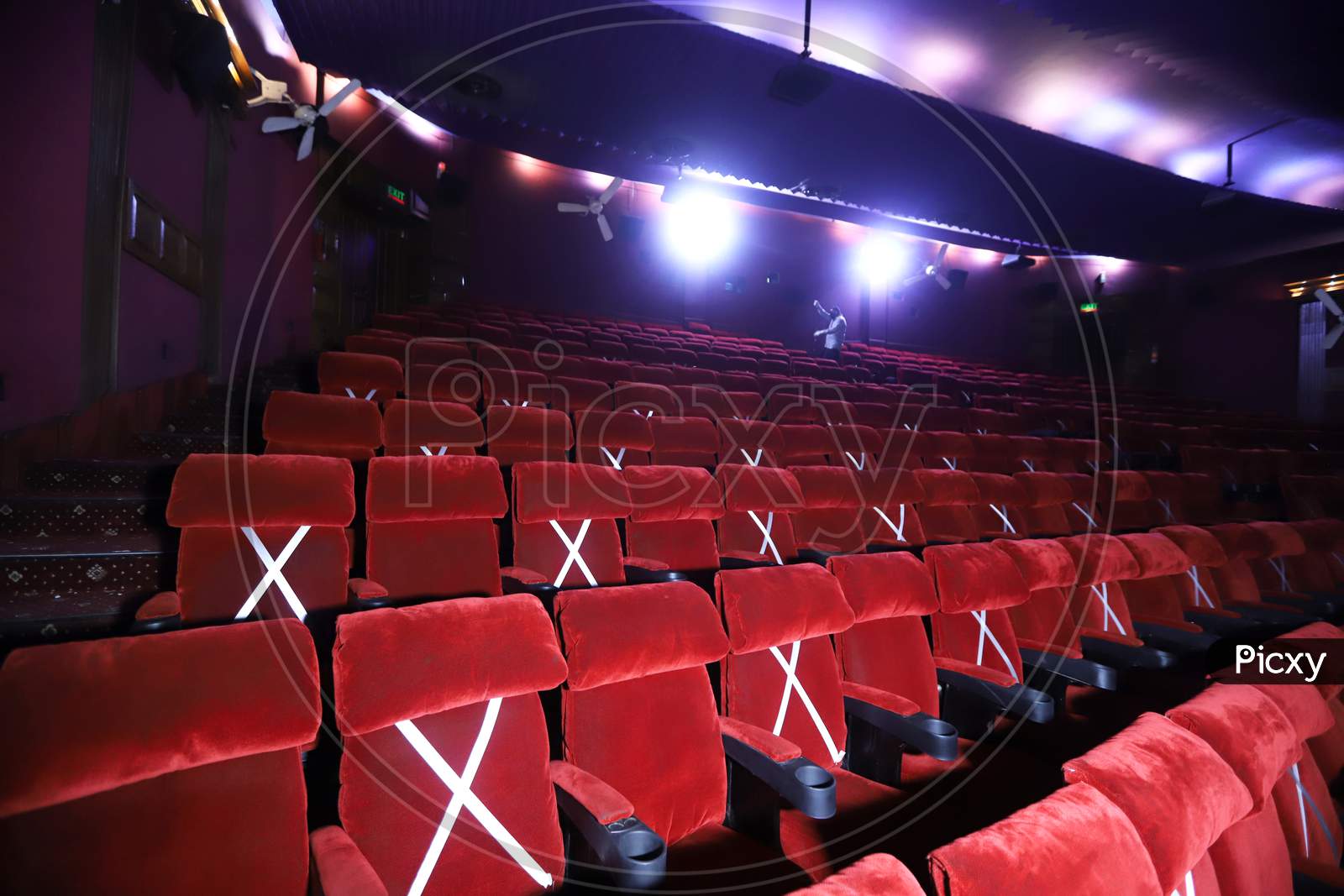 Image of Tape is displayed on seats to implement safe distancing measures  at a film theater in the Delite cinema in New Delhi, India, on October. 13,  2020.-QM241032-Picxy