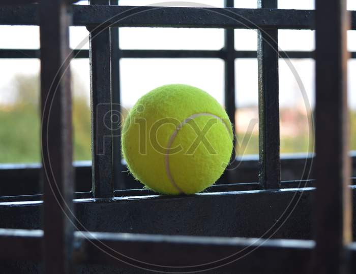 Tennis ball placed in iron grills
