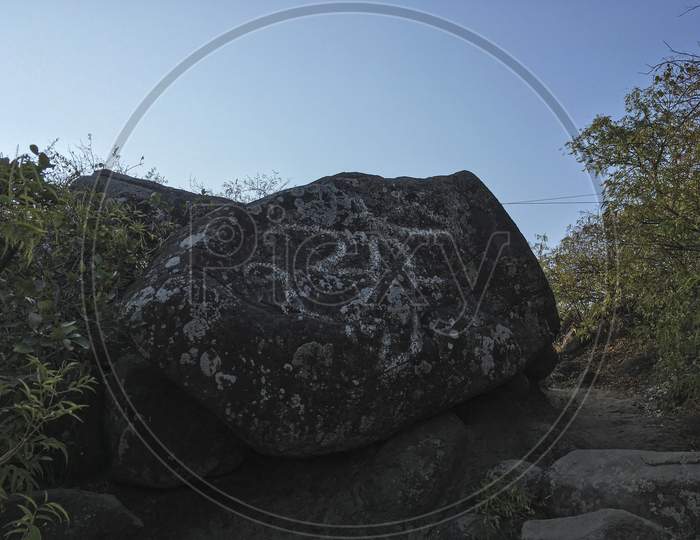 OM inscribed on a rock