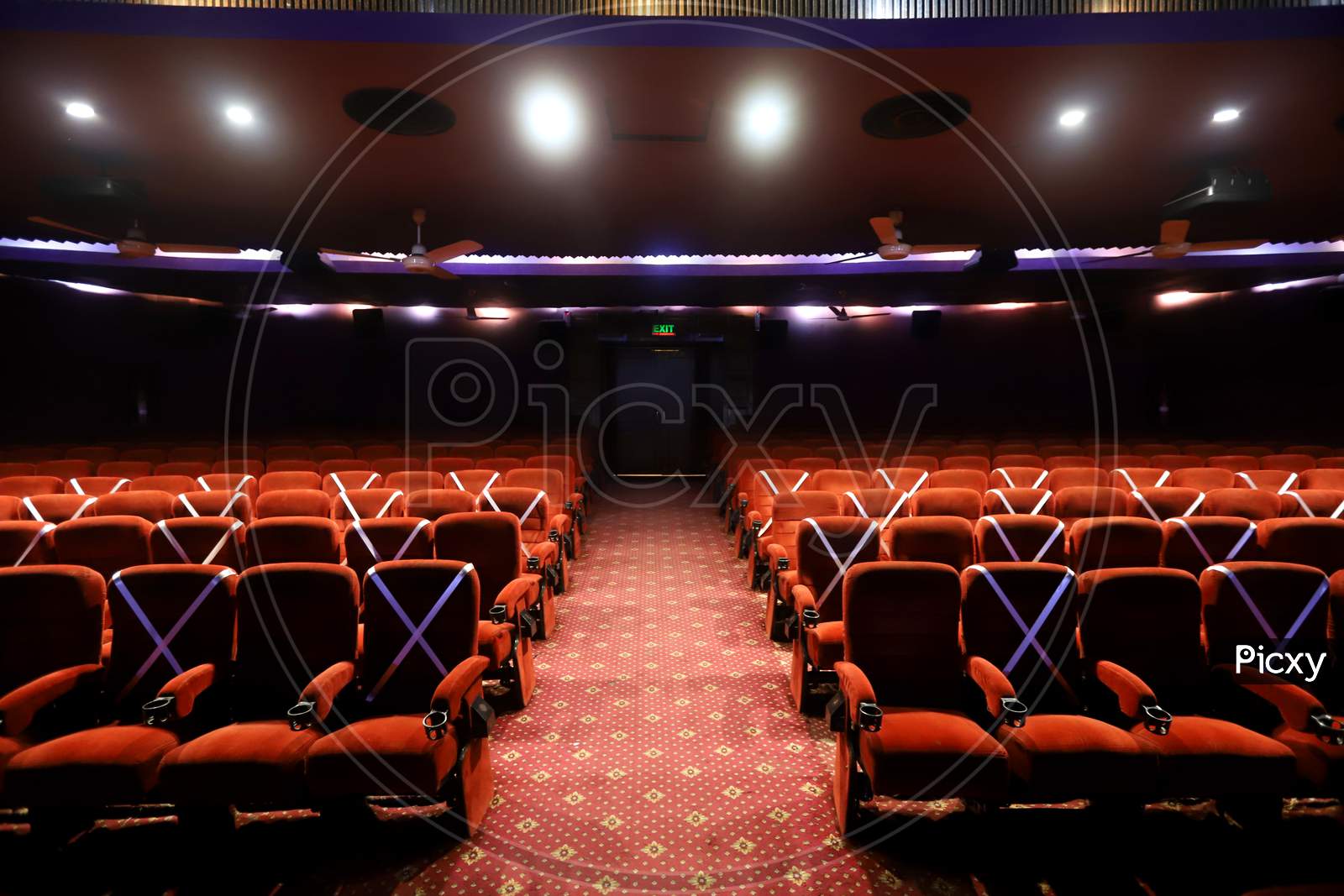 Tape is displayed on seats to implement safe distancing measures at a film theater in the  Delite cinema in New Delhi, India, on October. 13, 2020.