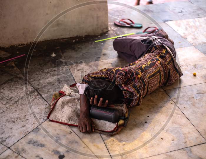 a homeless man sleeping on the floor