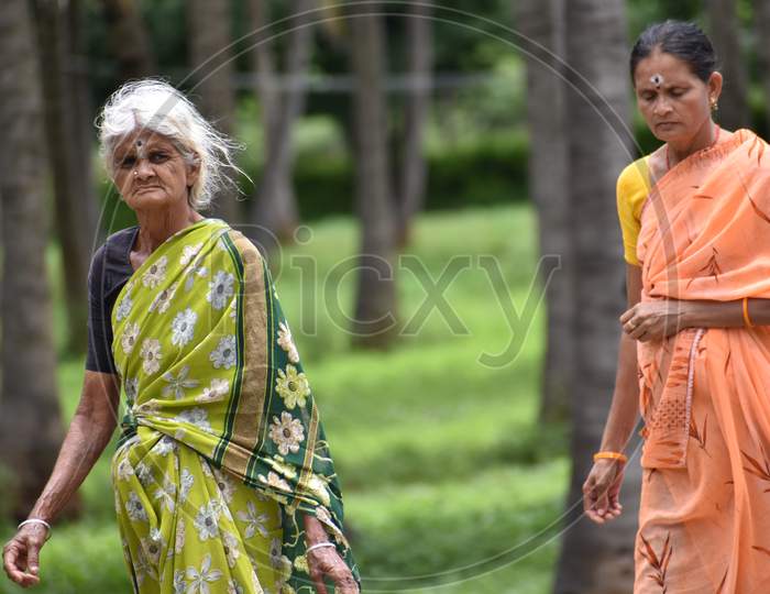 the grandma's walking to there field to work