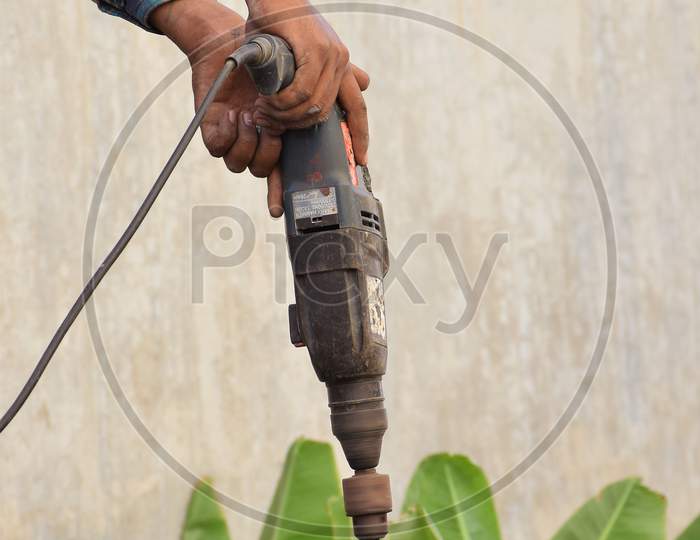 Worker using drilling machine