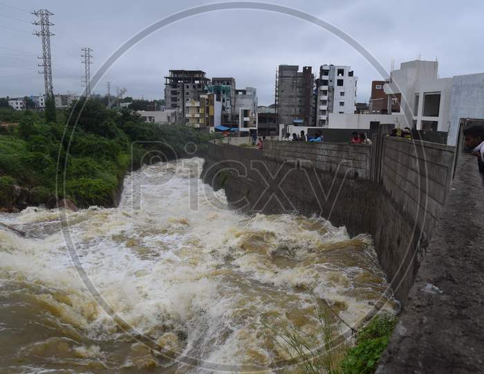 Water from Palle Cheruvu lake overflowing after its banks washed away due to the incessant rains in Hyderabad on October 14,2020.