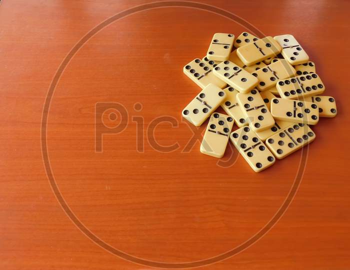 Closeup Of Playing Items(Dominoes)Isolated On Wooden Surface