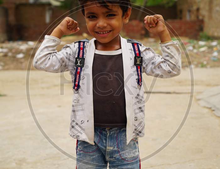 Happy boy child is smiling enjoying adopted life. Portrait of young boy in nature, park or outdoors. Concept of happy family or successful adoption or parenting.