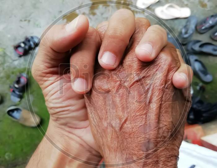 Closeup Of An Old Women Hand Over The Mans Hand
