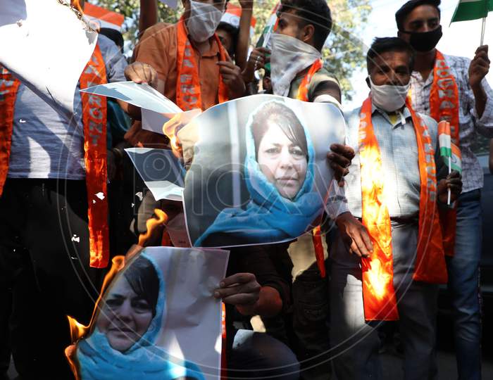 Shiv Sena Dogra Front activists holding a protest and burn the poster of former chief minister Mehbooba Mufti, who was released after over 14 months detention, in Jammu ,15 oct,2020.