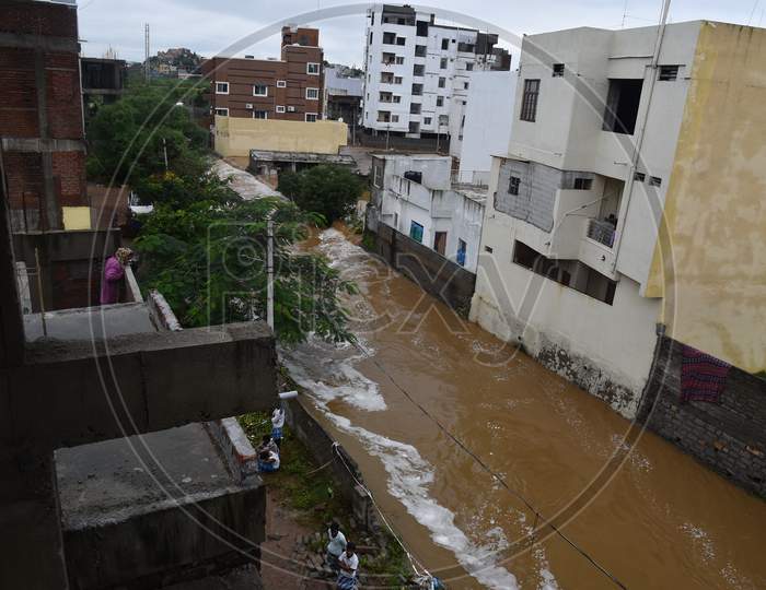 Water from Palle Cheruvu lake overflowing after its banks washed away due to the incessant rains in Hyderabad on October 14,2020.