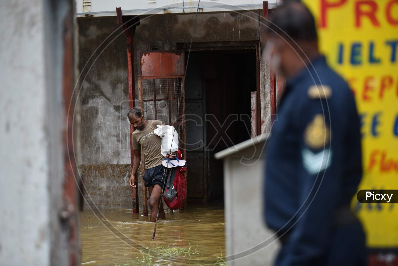 workers come out after being rescued by OCTOPUS team from a factory that got inundated due to the overflowing of Palle Cheruvu on October 14, 2020.