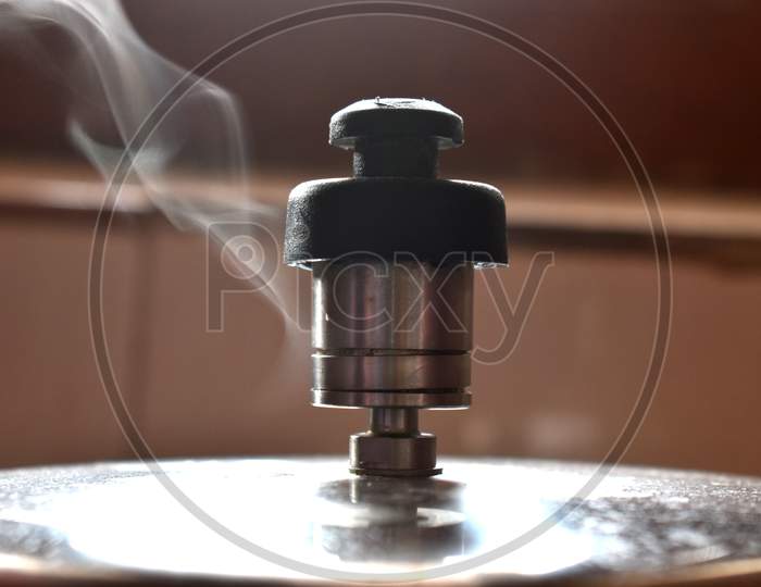 Smoke coming out of pressure cooker whistle