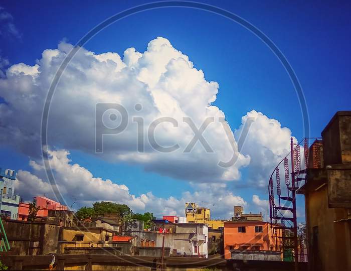Beautiful White Clouds and Blue Sky up on Urban Area