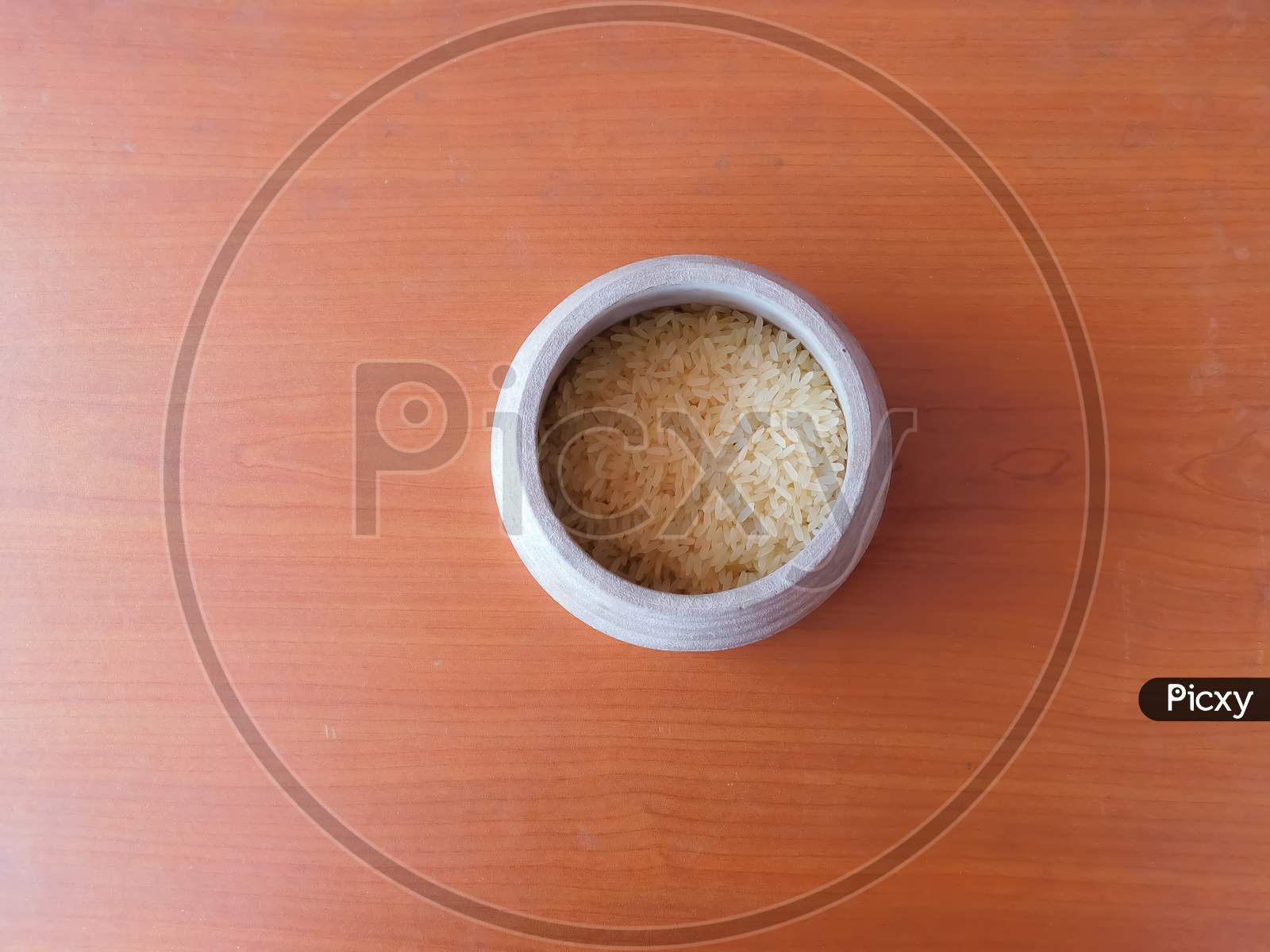 Closeup Of Rice'S In A Bowl Isolated On Wooden Surface