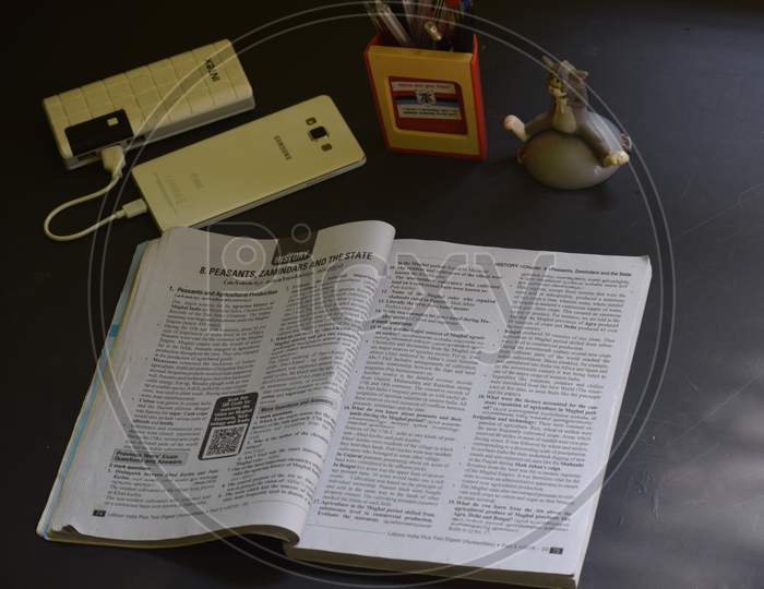 Closeup Of A Book And Other Tableware Items Isolated On Black Background