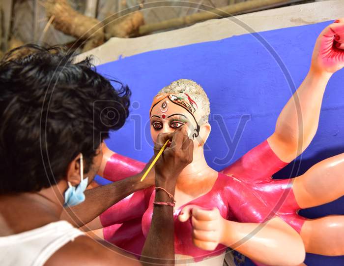 Guwahati: An artist gives final touches to an idol of Goddess Durga ahead of Durga Puja festival, in Guwahati, on Oct 16,2020